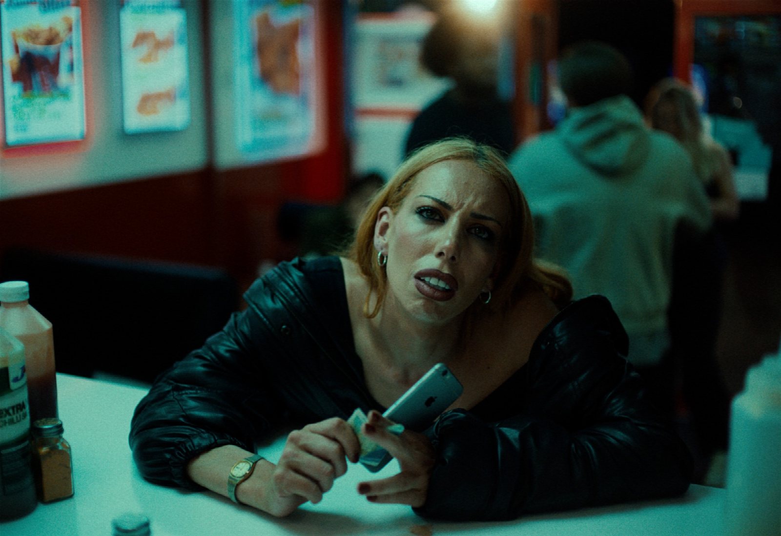 Elle Piper in MEAT: dishevelled, one shoe lost, framed among a circle of men under harsh light